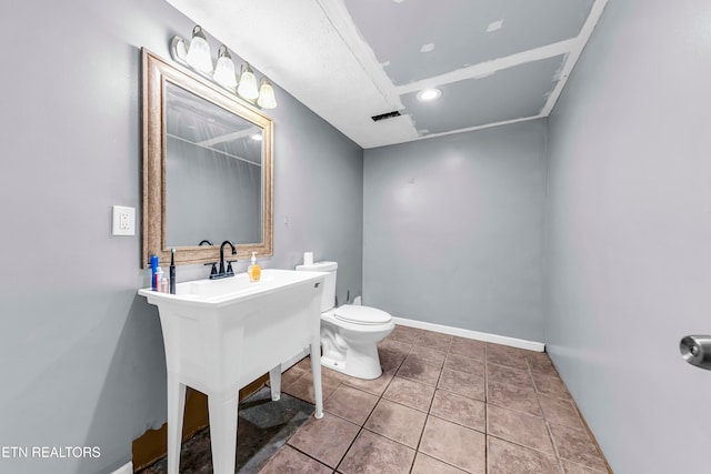 bathroom with tile patterned flooring and toilet