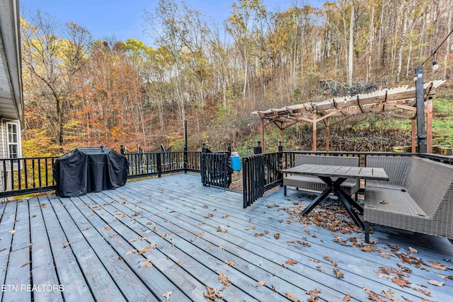 deck featuring a pergola and area for grilling