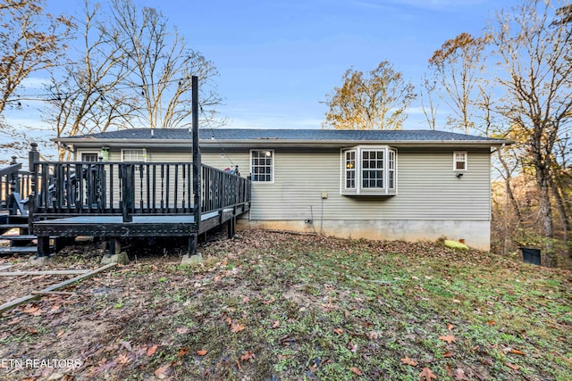 back of property with a wooden deck