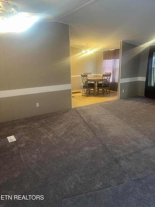 carpeted spare room featuring a textured ceiling