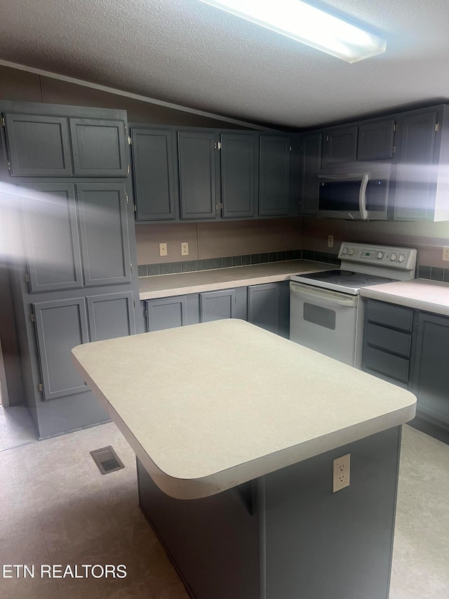 kitchen with a textured ceiling, white range with electric stovetop, lofted ceiling, and gray cabinetry