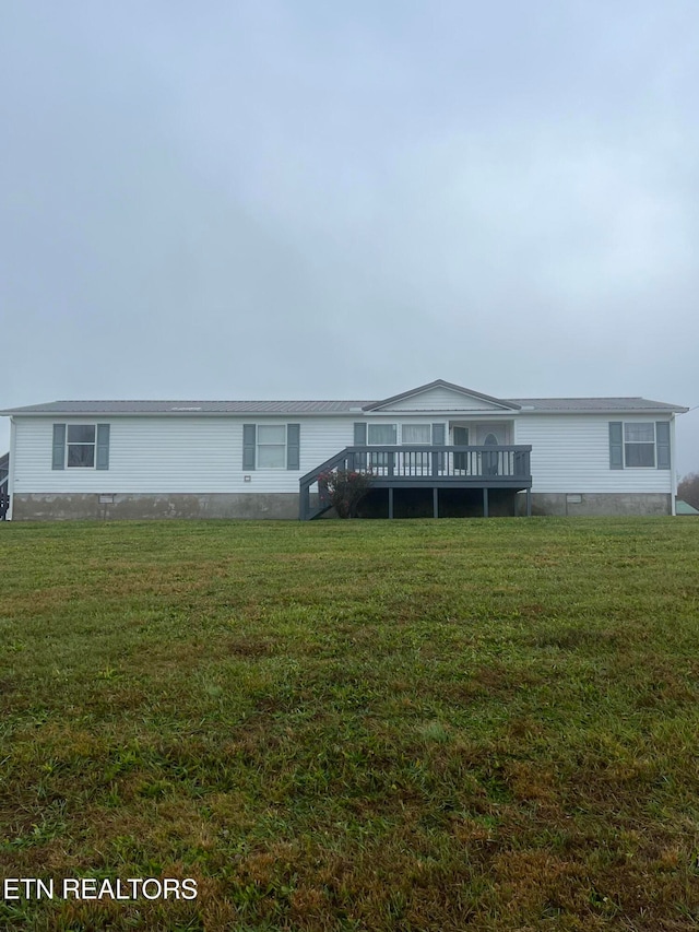 view of front facade featuring a deck and a front yard