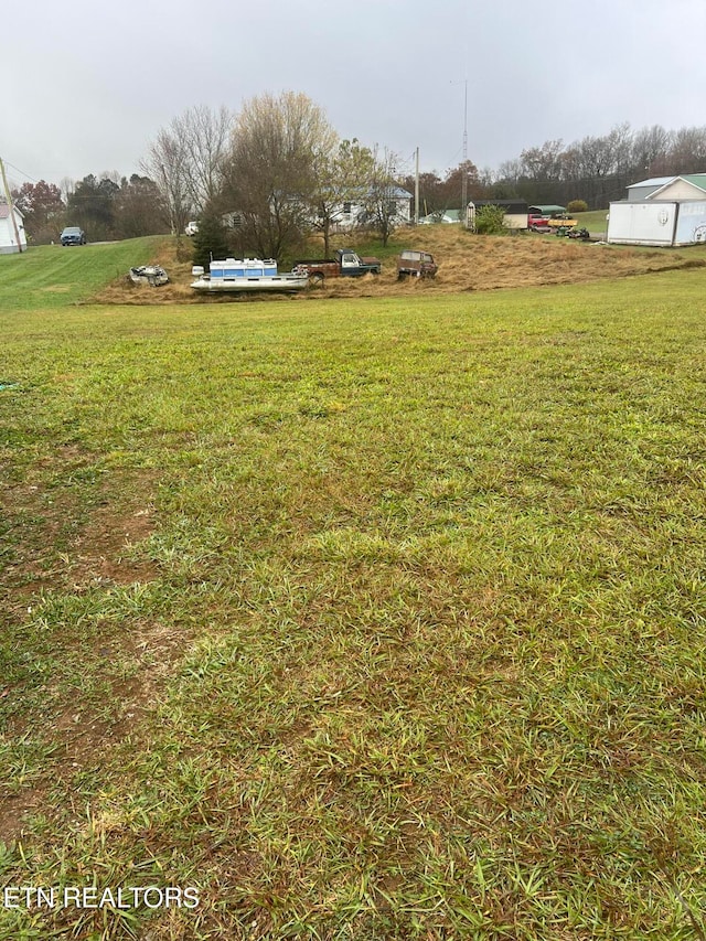 view of yard with a rural view