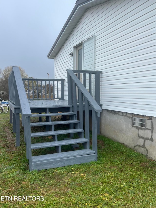 wooden deck with a lawn