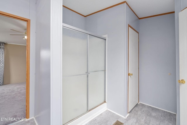 bathroom featuring a shower stall, ceiling fan, ornamental molding, and wood finished floors
