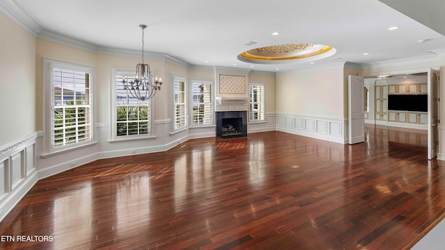 unfurnished living room with dark hardwood / wood-style flooring and ornamental molding