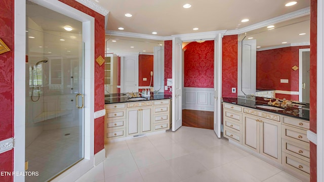 bathroom with tile patterned floors, crown molding, vanity, and an enclosed shower