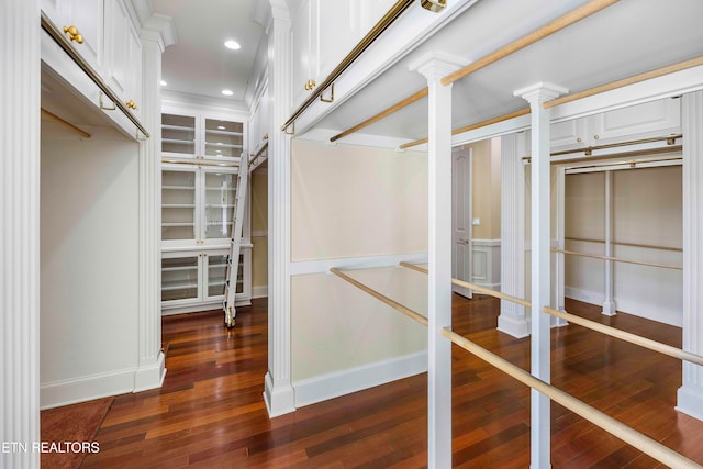 walk in closet with dark wood-type flooring