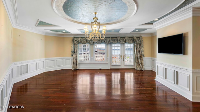 unfurnished dining area with dark hardwood / wood-style floors, french doors, crown molding, and a chandelier