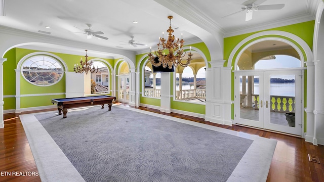 rec room featuring a water view, dark wood-type flooring, and french doors