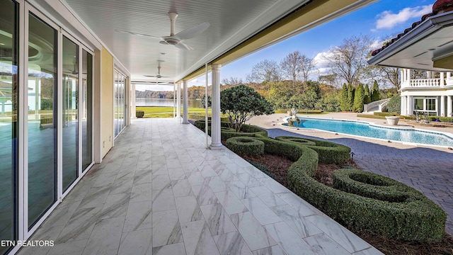 view of pool featuring ceiling fan and a patio area