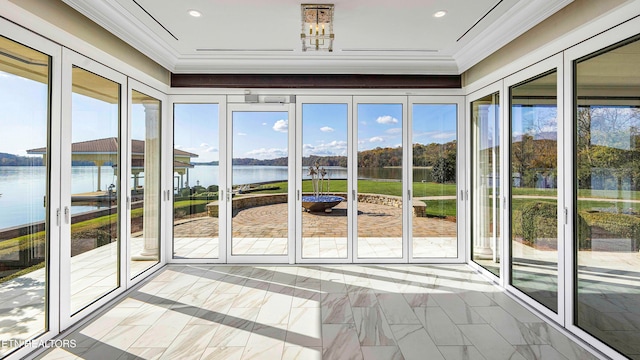 unfurnished sunroom with a water view