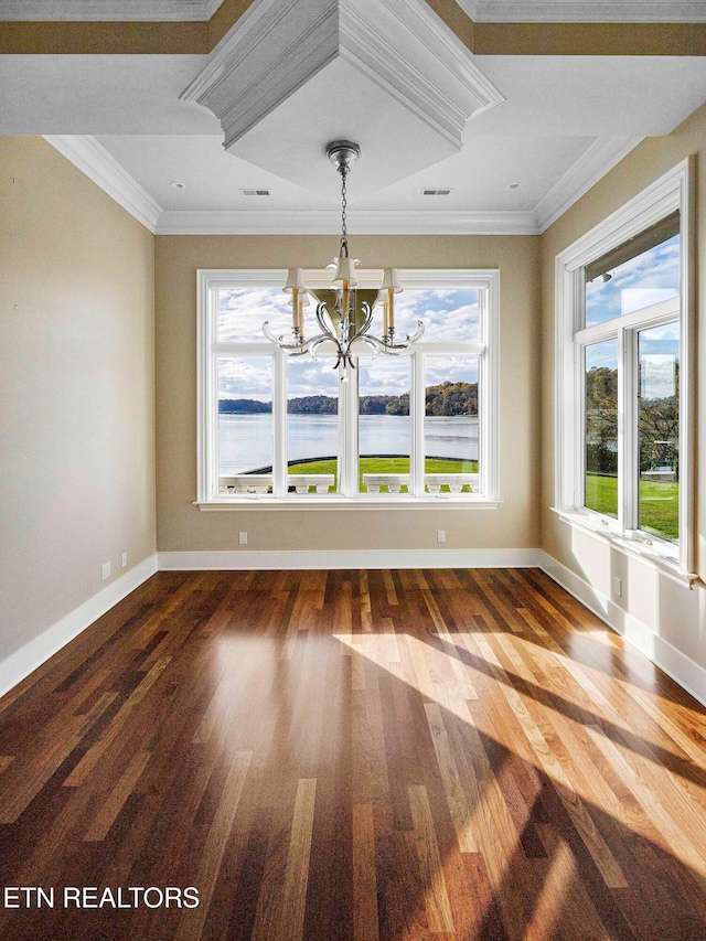 unfurnished dining area featuring crown molding, a water view, wood-type flooring, and an inviting chandelier