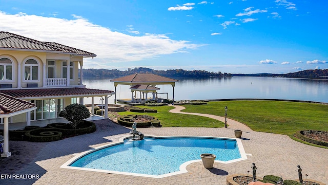 view of pool featuring a gazebo, a yard, a water view, and a patio area