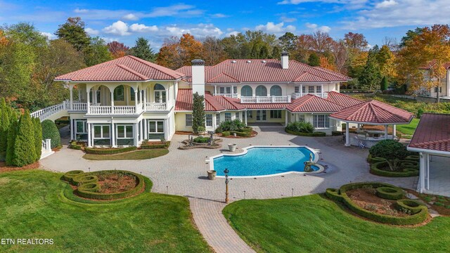 view of pool featuring a yard and a patio area