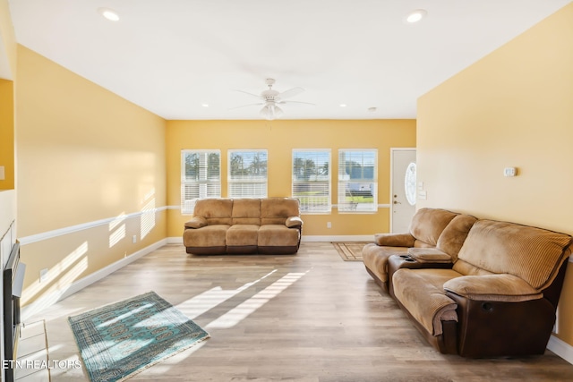 living room with ceiling fan and light hardwood / wood-style floors