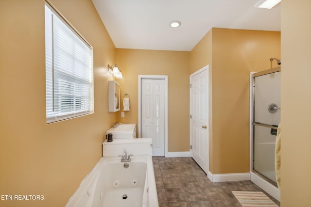 bathroom with plus walk in shower and tile patterned flooring