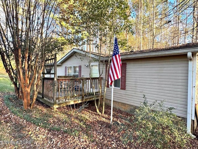 back of property with a wooden deck