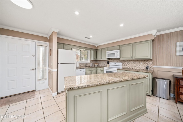 kitchen featuring white appliances, light tile patterned floors, and a center island