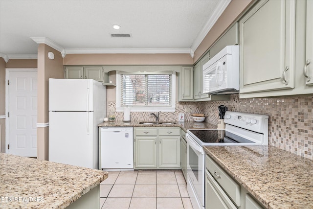 kitchen featuring sink, white appliances, light tile patterned floors, decorative backsplash, and crown molding