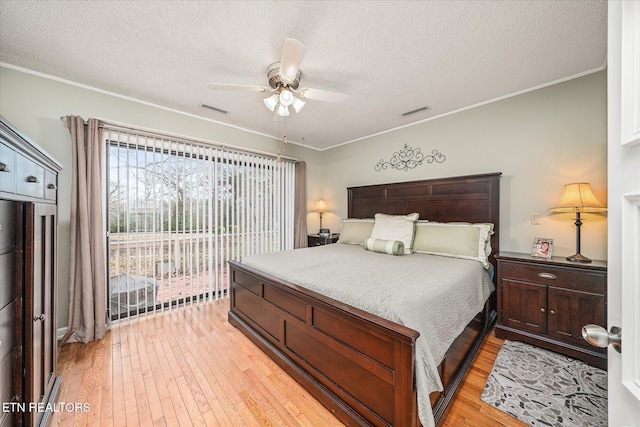 bedroom featuring ceiling fan, light wood-type flooring, access to outside, and ornamental molding