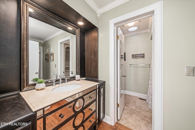 bathroom with vanity, a textured ceiling, and ornamental molding