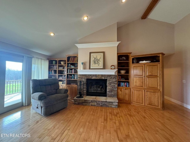 living room featuring a stone fireplace, beamed ceiling, high vaulted ceiling, and light wood-type flooring