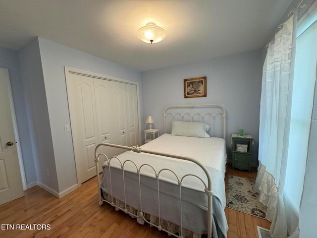 bedroom with hardwood / wood-style flooring and a closet