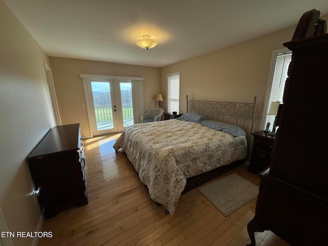 bedroom with access to exterior and light wood-type flooring