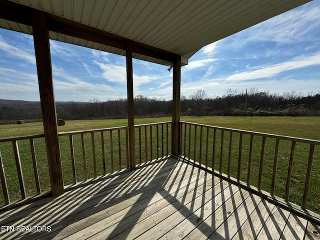 wooden terrace featuring a lawn