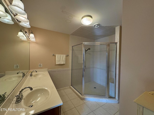 bathroom featuring tile patterned floors, vanity, and an enclosed shower