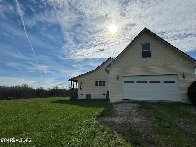 view of side of home featuring a garage and a yard