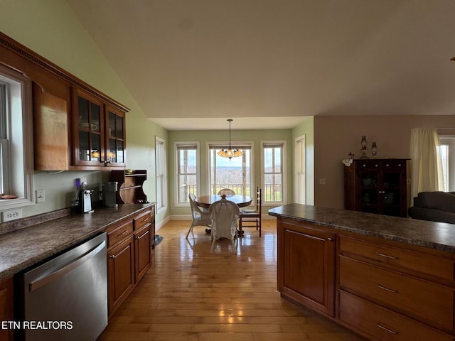 kitchen with pendant lighting, dishwasher, lofted ceiling, an inviting chandelier, and light wood-type flooring