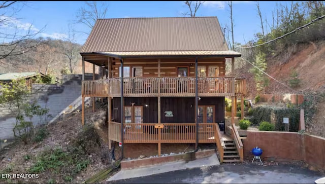 back of house with french doors and a deck