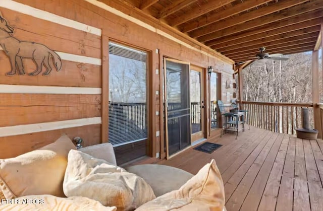 wooden deck featuring ceiling fan