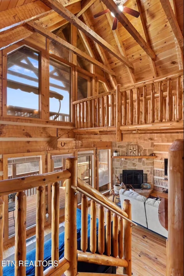 unfurnished living room with beamed ceiling, high vaulted ceiling, and wood ceiling