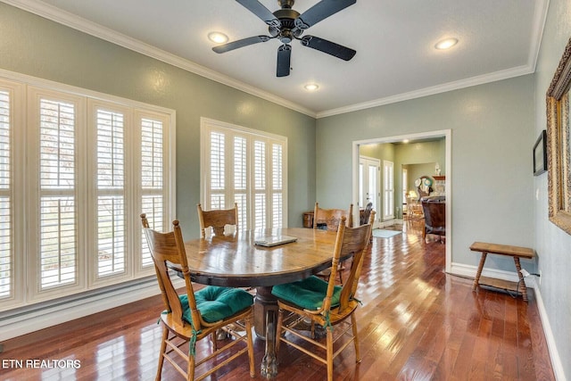 dining room featuring dark hardwood / wood-style flooring, ceiling fan, and crown molding