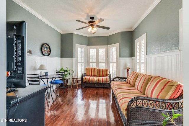 living room featuring dark hardwood / wood-style flooring, ceiling fan, and ornamental molding