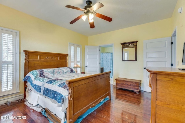 bedroom with dark hardwood / wood-style flooring and ceiling fan