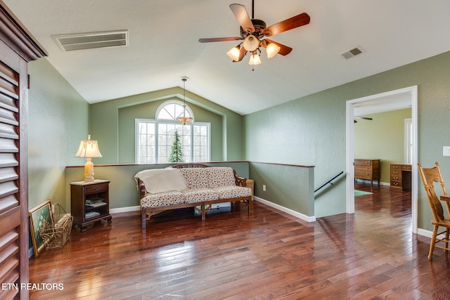 living area with lofted ceiling, ceiling fan, and dark wood-type flooring