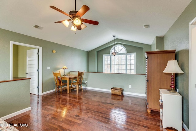 dining space with dark hardwood / wood-style floors, vaulted ceiling, and ceiling fan