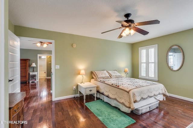 bedroom with ceiling fan and dark hardwood / wood-style flooring