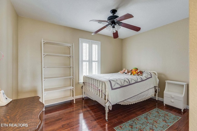 bedroom with ceiling fan and dark wood-type flooring