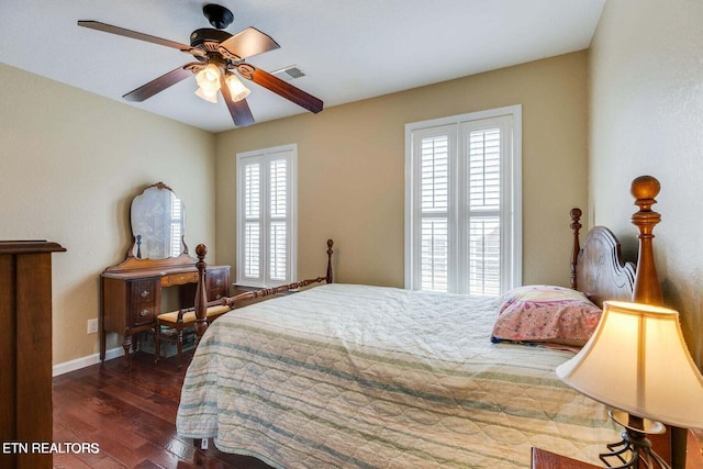 bedroom featuring multiple windows, ceiling fan, and dark hardwood / wood-style floors