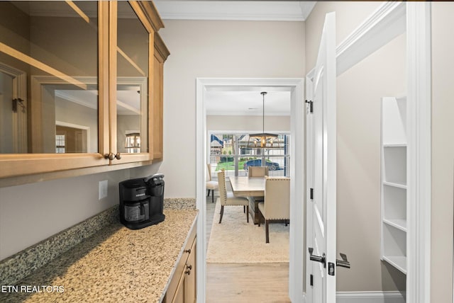 interior space featuring light wood-type flooring and crown molding