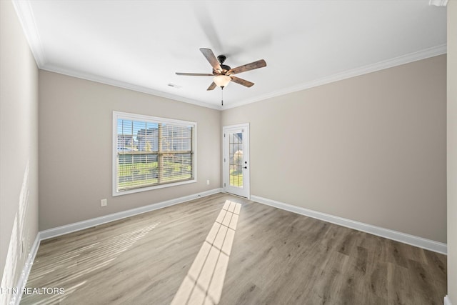 unfurnished room with ceiling fan, wood-type flooring, and ornamental molding