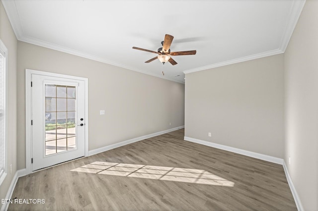 empty room featuring ceiling fan, light hardwood / wood-style floors, and crown molding