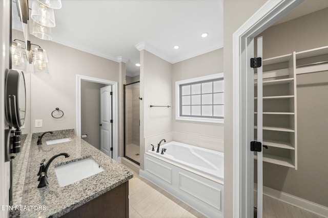 bathroom with plus walk in shower, crown molding, vanity, and tile patterned flooring