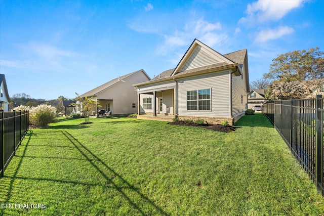 rear view of house with a yard