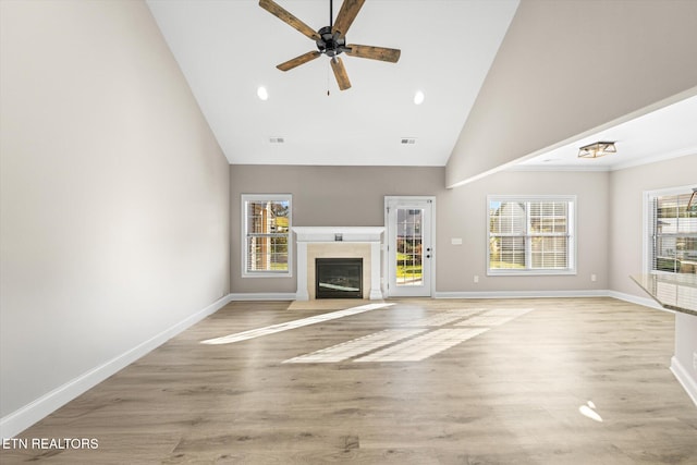 unfurnished living room with ceiling fan, light hardwood / wood-style floors, and high vaulted ceiling